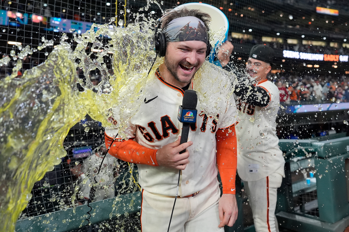 San Francisco Giants' Patrick Bailey is doused with gatorade by Willy Adames, right, after hitting a game-winning, three-run home run against the Los Angeles Dodgers in the seventh inning of a baseball game Wednesday, April 22, 2026, in San Francisco. (AP Photo/Tony Avelar)