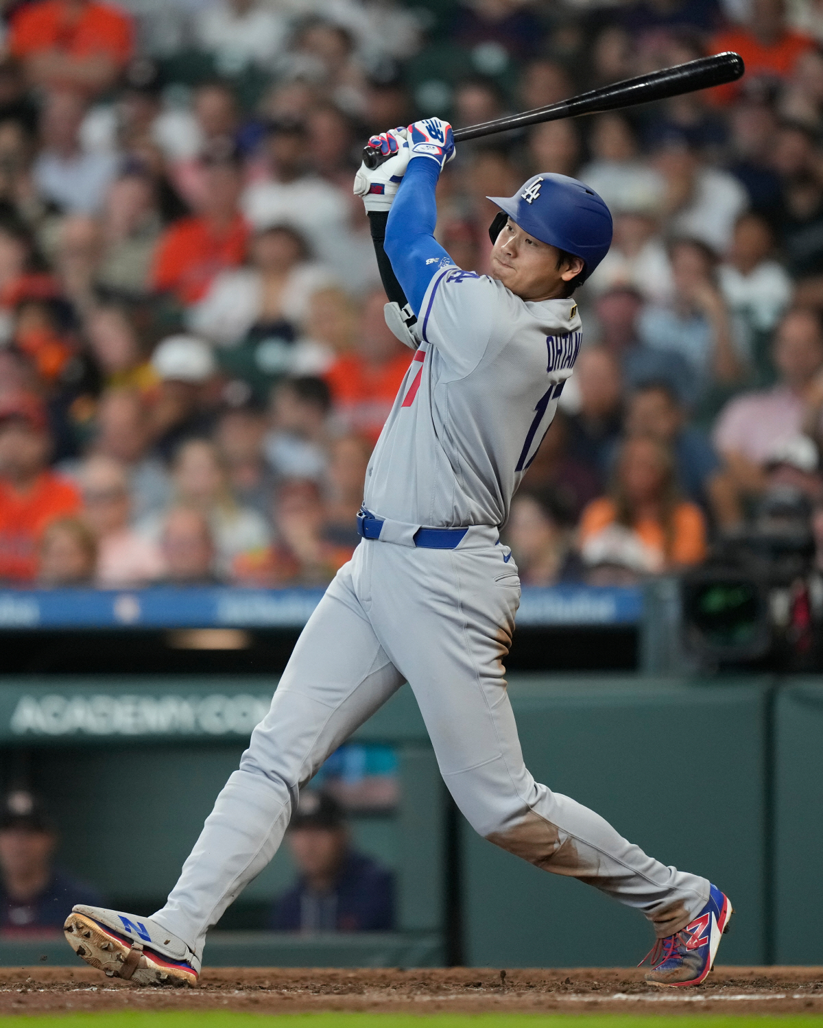 Los Angeles Dodgers designated hitter Shohei Ohtani singles during the fifth inning of a baseball game against the Houston Astros in Houston, Wednesday, May 6, 2026. (AP Photo/Ashley Landis)