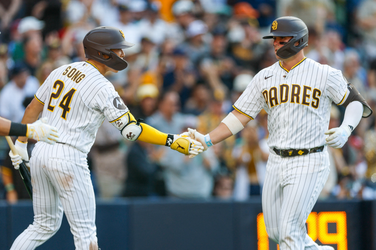 May 9, 2026; San Diego, California, USA; San Diego Padres first baseman Ty France (25) celebrates with second baseman Sung-Mun Song (24) after hitting a one run home run during the fifth inning against the St. Louis Cardinals at Petco Park. Mandatory Credit: David Frerker-Imagn Images