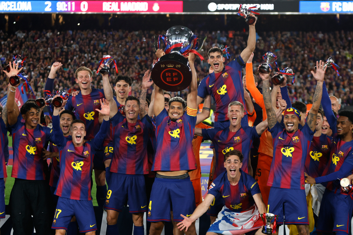 Barcelona players lift the trophy after winning the Spanish La Liga soccer match against Real Madrid to clinch the Spanish league title in Barcelona, Spain, Sunday, May 10, 2026. (AP Photo/Joan Monfort)