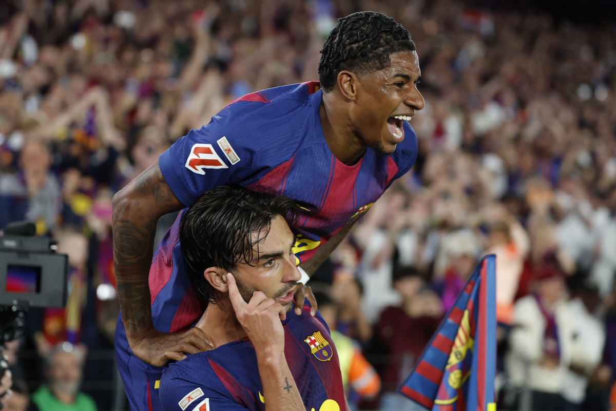 epa12946378 FC Barcelona's Ferran Torres (bottom) celebrates with his teammate Marcus Rashford after scoring the 2-0 goal during the Spanish LaLiga soccer match between FC Barcelona and Real Madrid, in Barcelona, Spain, 10 May 2026. EPA/ANDREU DALMAU