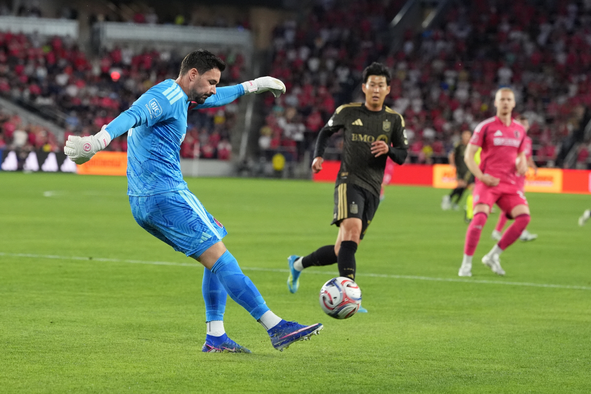 St. Louis City goalkeeper Roman Burki, left, clears the ball as Los Angeles FC's Son Heung-Min watches during the first half of an MLS soccer match Wednesday, May 13, 2026, in St. Louis. (AP Photo/Jeff Roberson)