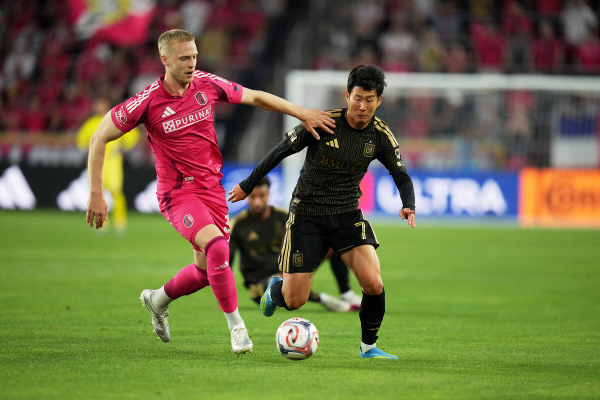 St. Louis City's Timo Baumgartl, left, and Los Angeles FC's Son Heung-Min (7) chase after a loose ball during the first half of an MLS soccer match Wednesday, May 13, 2026, in St. Louis. (AP Photo/Jeff Roberson)
