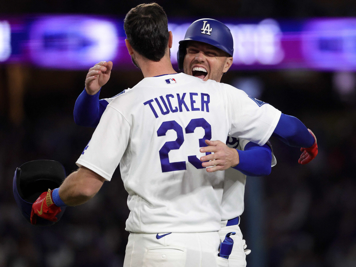 LOS ANGELES, CALIFORNIA - APRIL 27: Kyle Tucker #23 of the Los Angeles Dodgers hugs Freddie Freeman #5 after hitting a two run walk-off single against the Miami Marlins in the ninth inning at Dodger Stadium on April 27, 2026 in Los Angeles, California. Ronald Martinez/Getty Images/AFP (Photo by RONALD MARTINEZ / GETTY IMAGES NORTH AMERICA / Getty Images via AFP)