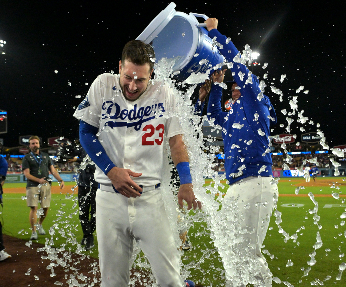 Apr 27, 2026; Los Angeles, California, USA; Los Angeles Dodgers right fielder Kyle Tucker (23) gets doused with a cooler of ice water by right fielder Alex Call (12) after hitting a walk-off single to defeat the Miami Marlins in the ninth inning at Dodger Stadium. Mandatory Credit: Jayne Kamin-Oncea-Imagn Images