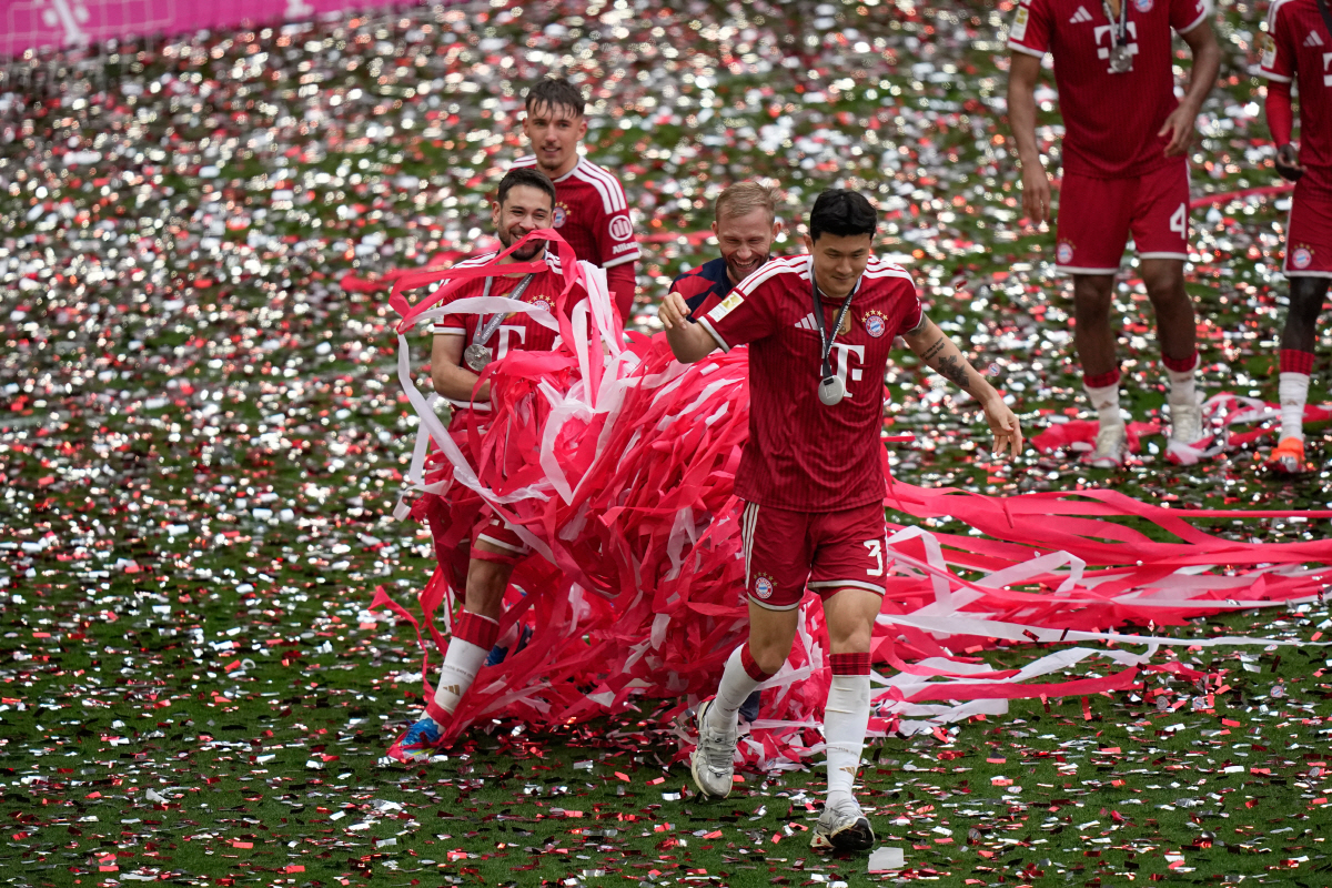 Bayern's Kim Min-jae, right, celebrates with teammates the Bundesliga title at the end of the soccer match between Bayern and FC Cologne in Munich, Germany, Saturday, May 16, 2026. (AP Photo/Matthias Schrader) THE DEUTSCHE FUSSBALL LIGA DFL DOES NOT ALLOW ITS IMAGES TO BE USED AS SEQUENCES TO EMULATE VIDEO
