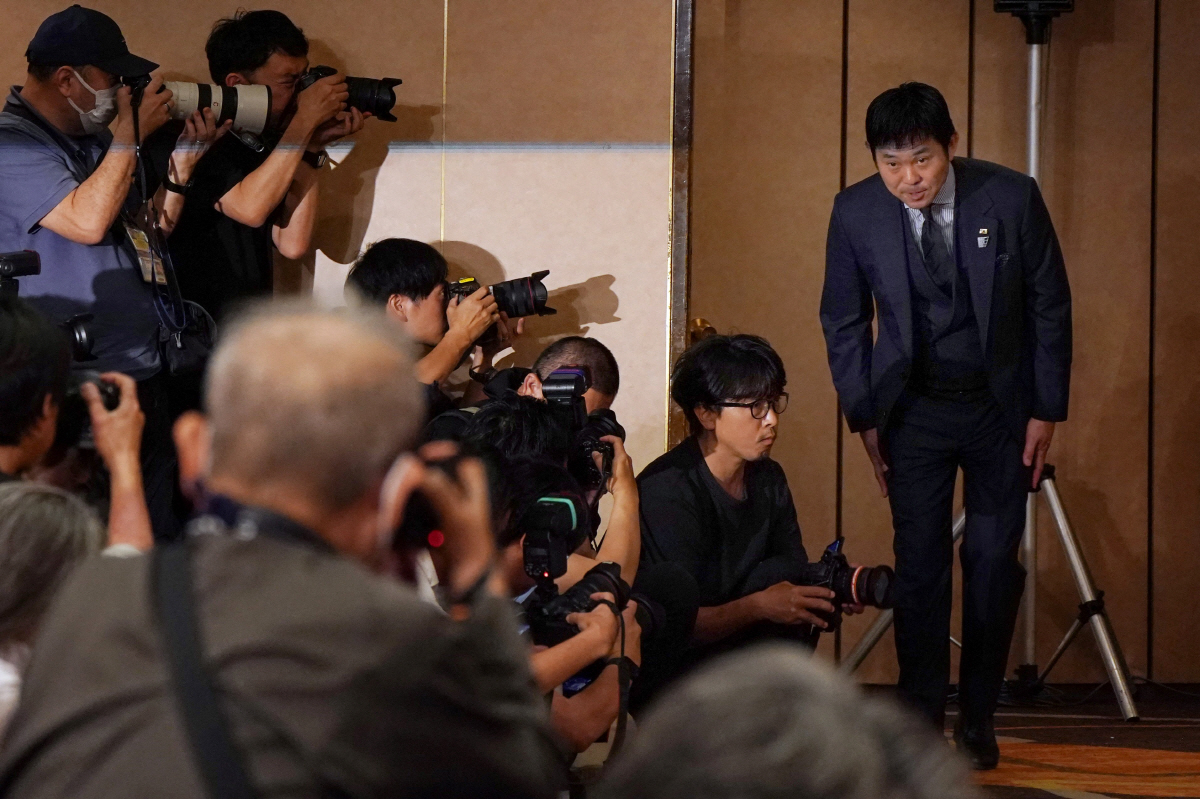 Japan's national football team head coach Hajime Moriyasu (R) bows to the media as he leaves after a press conference to officially announce the members of Japan's 2026 World Cup squad at a hotel in Tokyo on May 15, 2026. (Photo by Kazuhiro NOGI / AFP)
