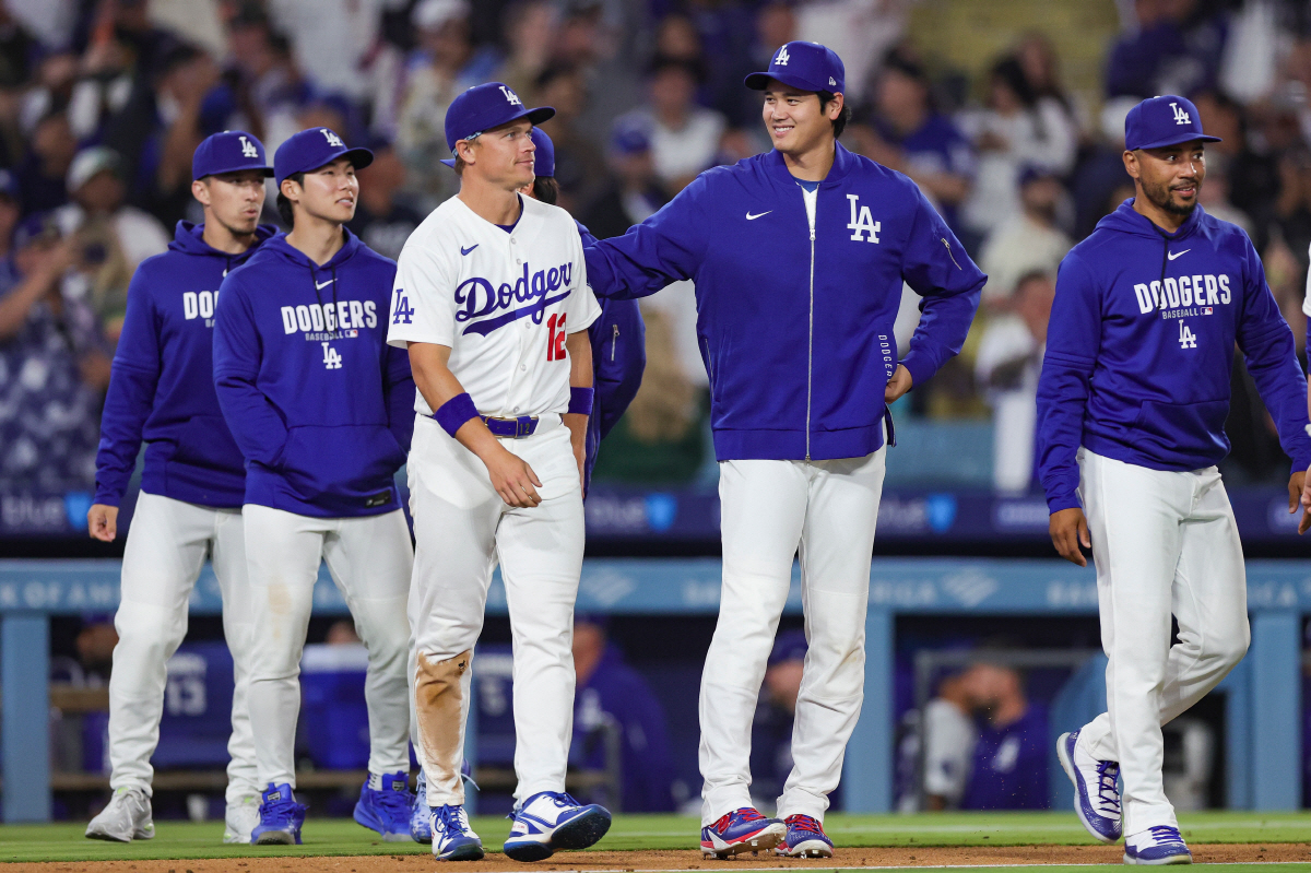 Los Angeles Dodgers pitcher Shohei Ohtani, center, reacts with Tommy Edman, Hyeseong Kim, Alex Call, and Mookie Betts, from left, after the team's win against the San Francisco Giants in a baseball game Thursday, May 14, 2026, in Los Angeles. (AP Photo/Ryan Sun)