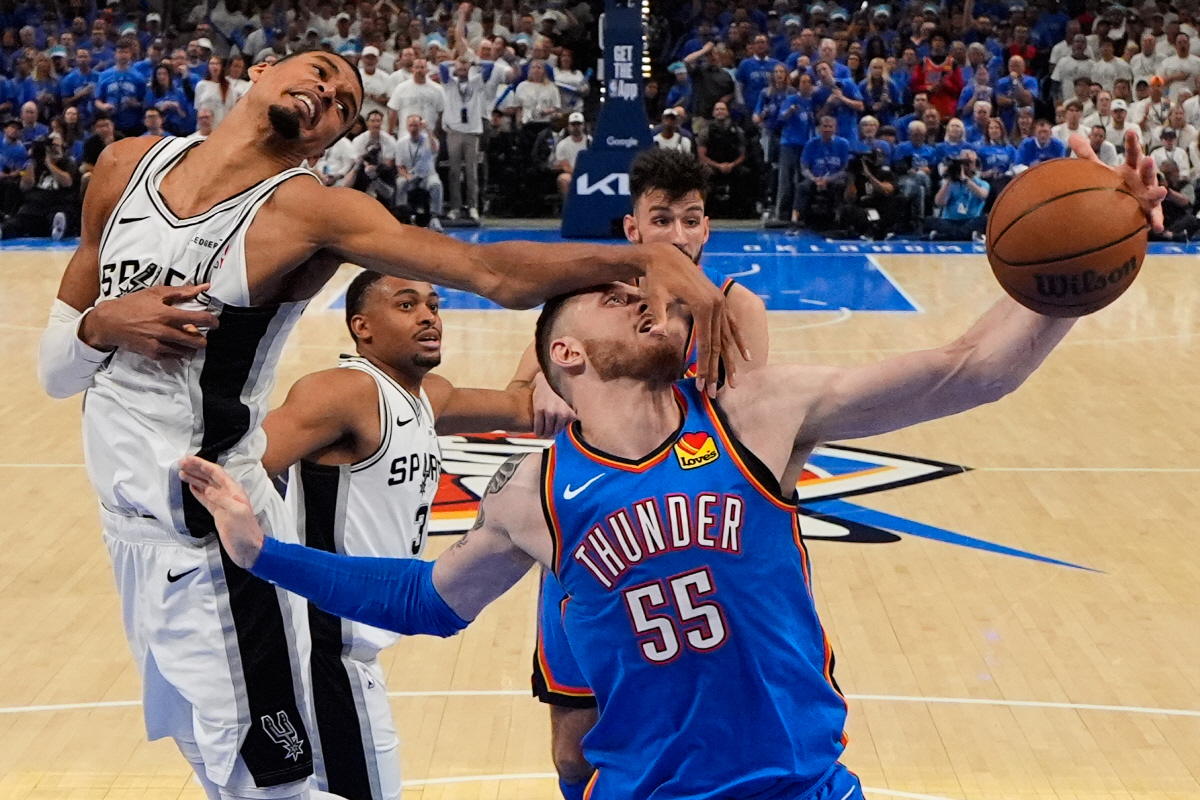 San Antonio Spurs forward Victor Wembanyama (1) defends against Oklahoma City Thunder center Isaiah Hartenstein (55) during the second half of Game 2 in the Western Conference finals NBA basketball playoffs series Wednesday, May 20, 2026, in Oklahoma City. (AP Photo/Nate Billings)