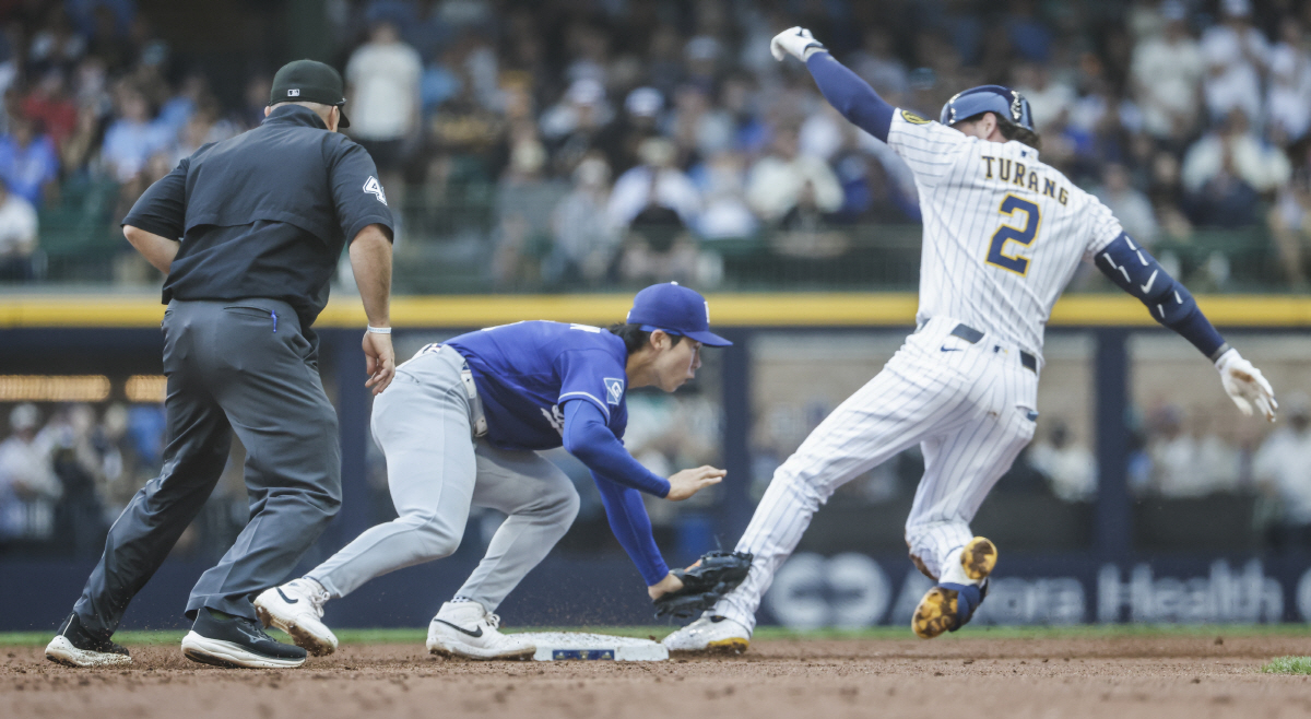 second base umpire Nick Mahrley (L) watches as Los Angeles Dodgers shortstop Hyeseong Kim (C) tags out Milwaukee Brewers second baseman Brice Turang (R) as Turang tries to turn a base hit into a double in the third inning of the MLB game between the Los Angeles Dodgers and the Milwaukee Brewers at American Family Field in Milwaukee, Wisconsin on Sunday, May 24, 2026. Photo by Tannen Maury/UPI