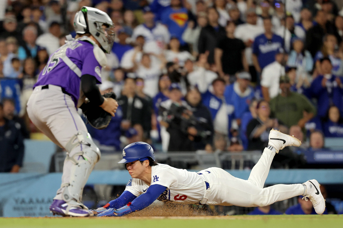 LOS ANGELES, CALIFORNIA - MAY 25: Hyeseong Kim #6 of the Los Angeles Dodgers slides into home plate against Hunter Goodman #15 of the Colorado Rockies during the seventh inning at Dodger Stadium on May 25, 2026 in Los Angeles, California. Katelyn Mulcahy/Getty Images/AFP (Photo by Katelyn Mulcahy / GETTY IMAGES NORTH AMERICA / Getty Images via AFP)