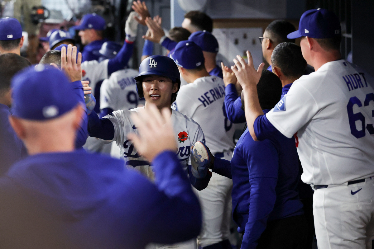 Los Angeles Dodgers' Hyeseong Kim celebrates in the dugout with teammates after scoring off of a sacrifice fly by Mookie Betts during the seventh inning of a baseball game against the Colorado Rockies, Monday, May 25, 2026, in Los Angeles. (AP Photo/Jessie Alcheh)