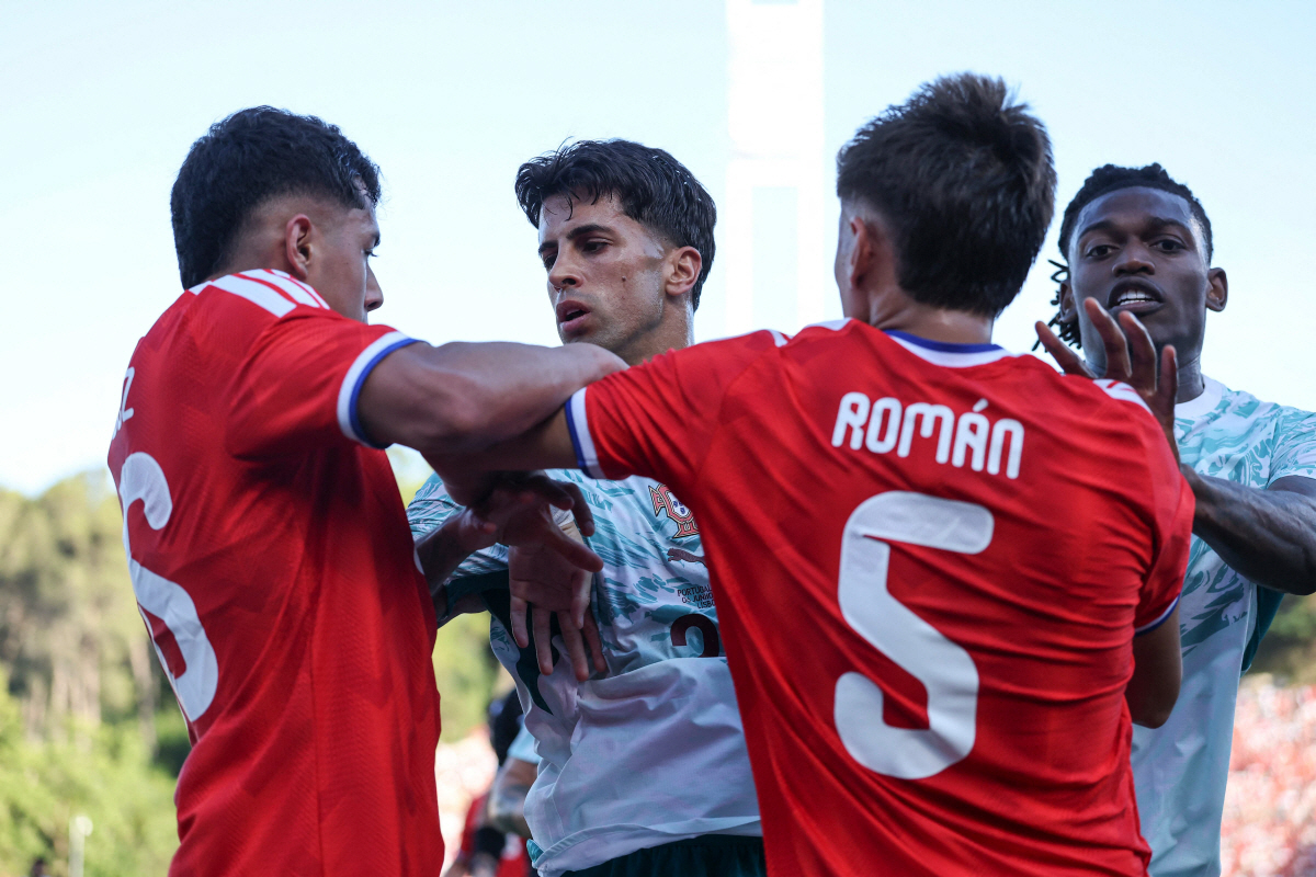 Portugal?s defender #20 Joao Cancelo (2L) and Portugal?s forward #17 Rafael Leao (R) argue with Chile?s defender #26 Felipe Faundez (L) and Chile?s defender #5 Ivan Roman during the international friendly football match between Portugal and Chile at Estadio Nacional do Jamor in Oeiras, on June 6, 2026. (Photo by PATRICIA DE MELO MOREIRA / AFP)