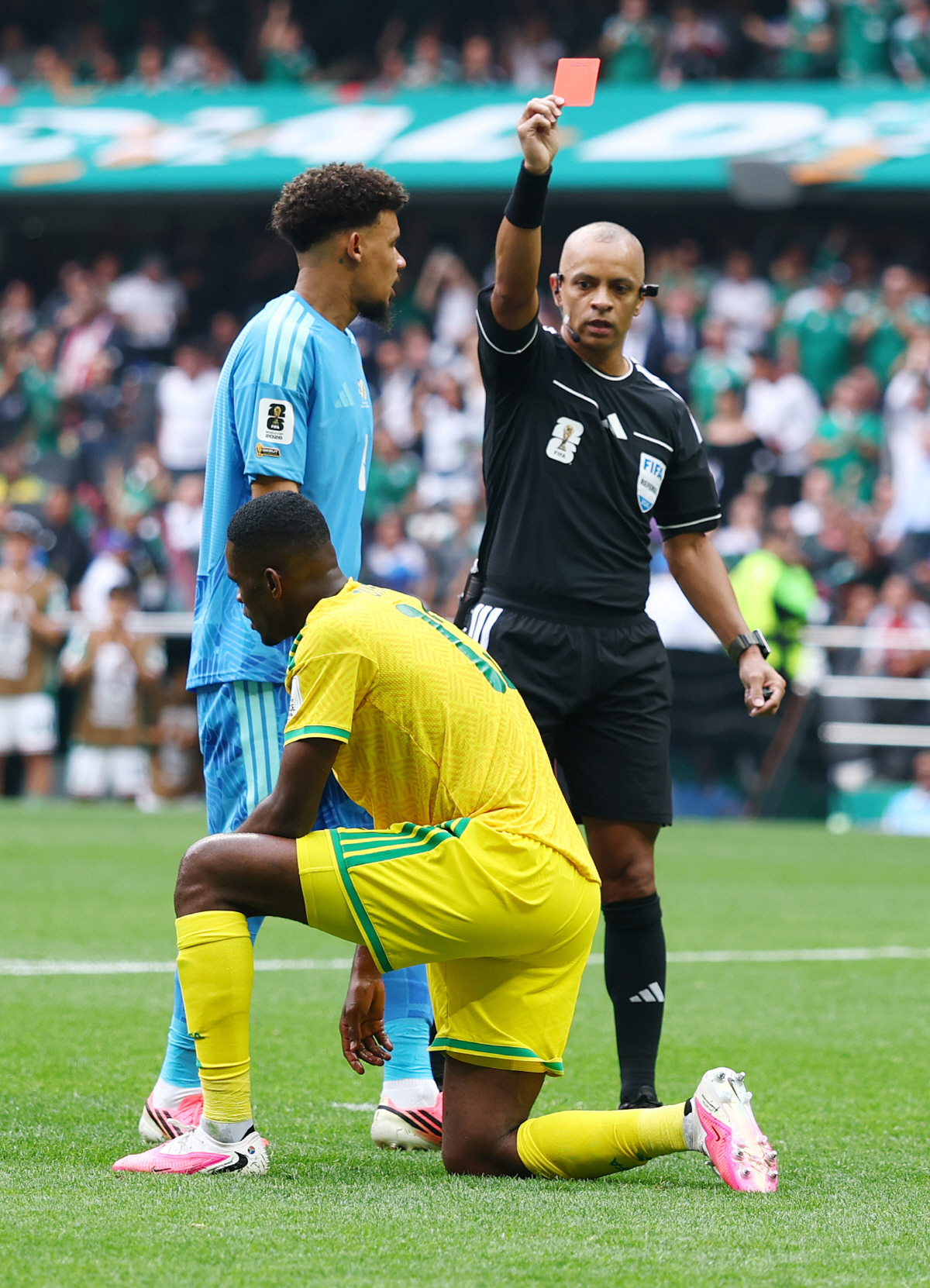 Referee Wilton Pereira Sampaio shows South Africa's Sphephelo Sithole a red card after he tackled Mexico's Brian Gutierrez just outside the box in the second half of a FIFA World Cup match at Aztec Stadium in Mexico City, Mexico, on Thursday, June 11, 2026. Photo by Christian Brunskill/UPI