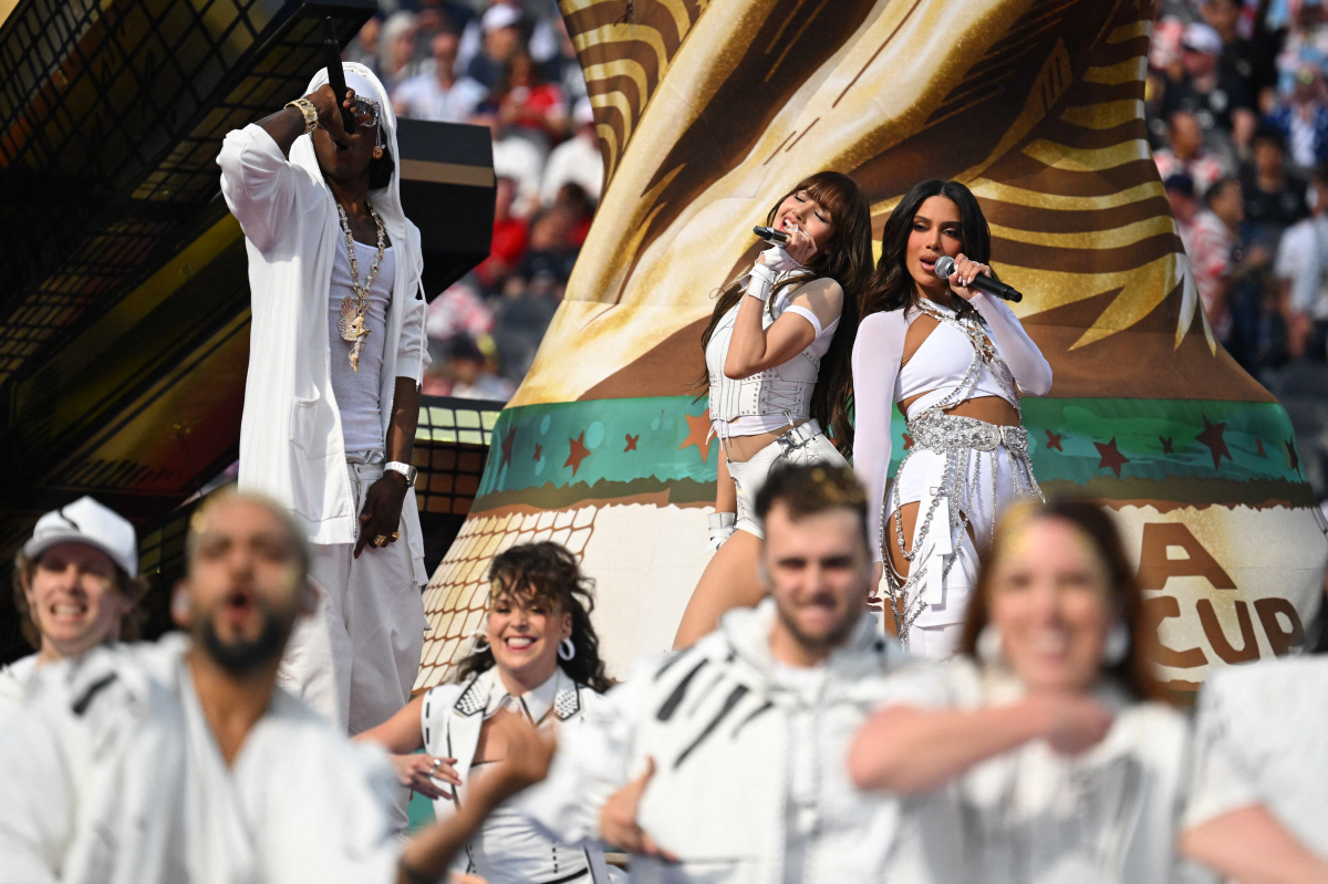 Nigerian rapper Rema (L), Thai rapper Lisa (C) and Brazilian singer-songwriter Anitta (R) perform during the opening ceremony of the 2026 World Cup football tournament ahead of the Group D football match between USA and Paraguay at the Los Angeles Stadium in Inglewood on June 12, 2026. (Photo by Patrick T. Fallon / AFP)