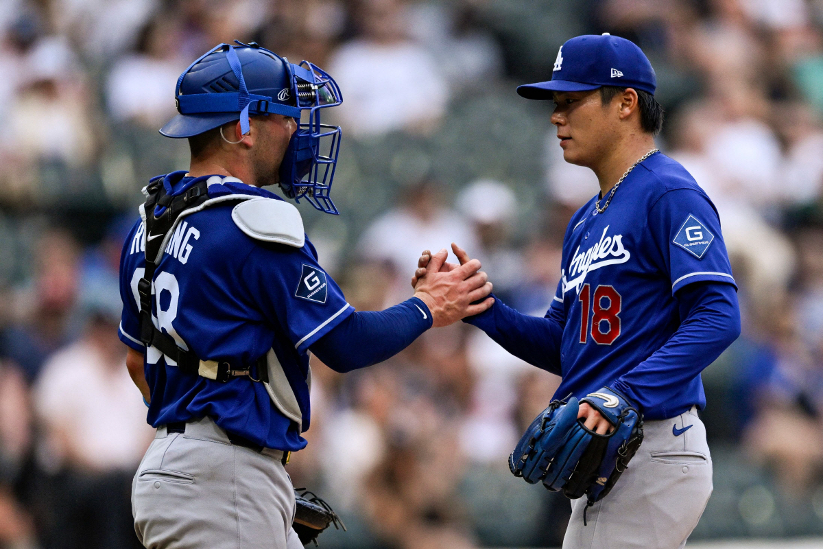 CHICAGO, ILLINOIS - JUNE 13: Dalton Rushing #68 high fives Yoshinobu Yamamoto #18 of the Los Angeles Dodgers as Yamamoto exits the game in the ninth inning against the Chicago White Sox at Rate Field on June 13, 2026 in Chicago, Illinois. Zoe Davis/Getty Images/AFP (Photo by Zoe Davis / GETTY IMAGES NORTH AMERICA / Getty Images via AFP)