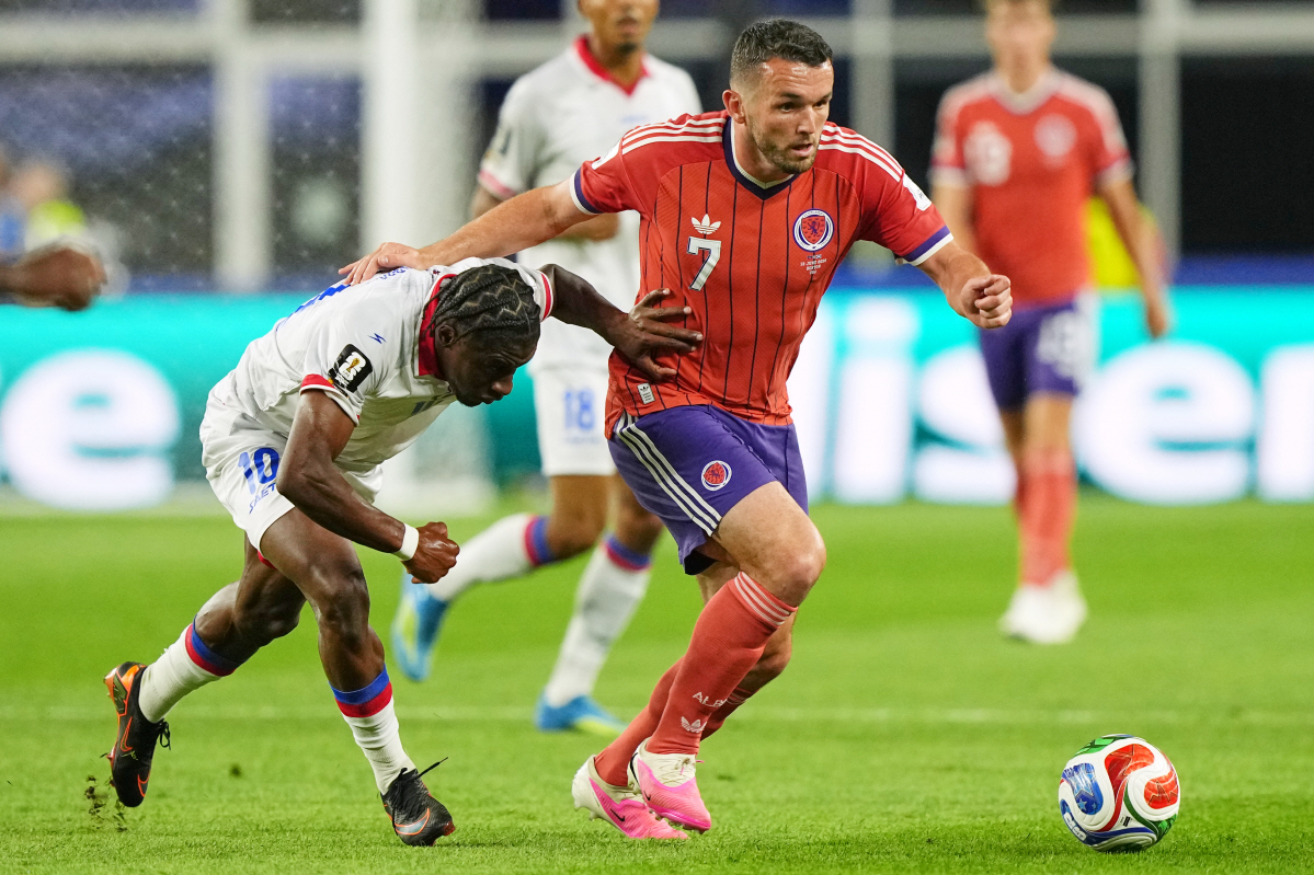 Scotland's John McGinn (7) and Haiti's Jean-Ricner Bellegarde (10) battle for the ball during the World Cup Group C soccer match between Haiti and Scotland in Foxborough, Mass., near Boston, Saturday, June 13, 2026. (AP Photo/Martin Meissner)