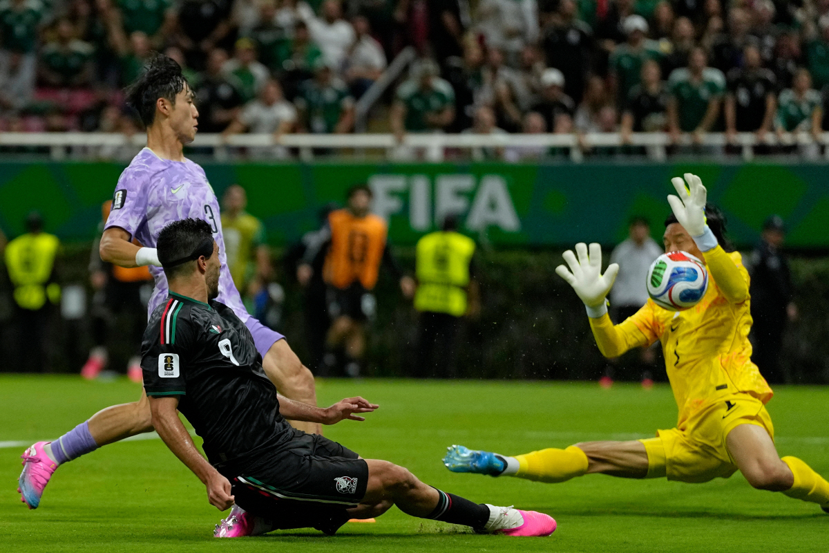 Mexico's Raul Jimenez (9), front, tries a shoot next to South Korea goalkeeper Kim Seung-gyu (1) during the World Cup Group A soccer match between Mexico and South Korea in Zapopan, near Guadalajara, Mexico, Thursday, June 18, 2026. (AP Photo/Ricardo Mazalan)