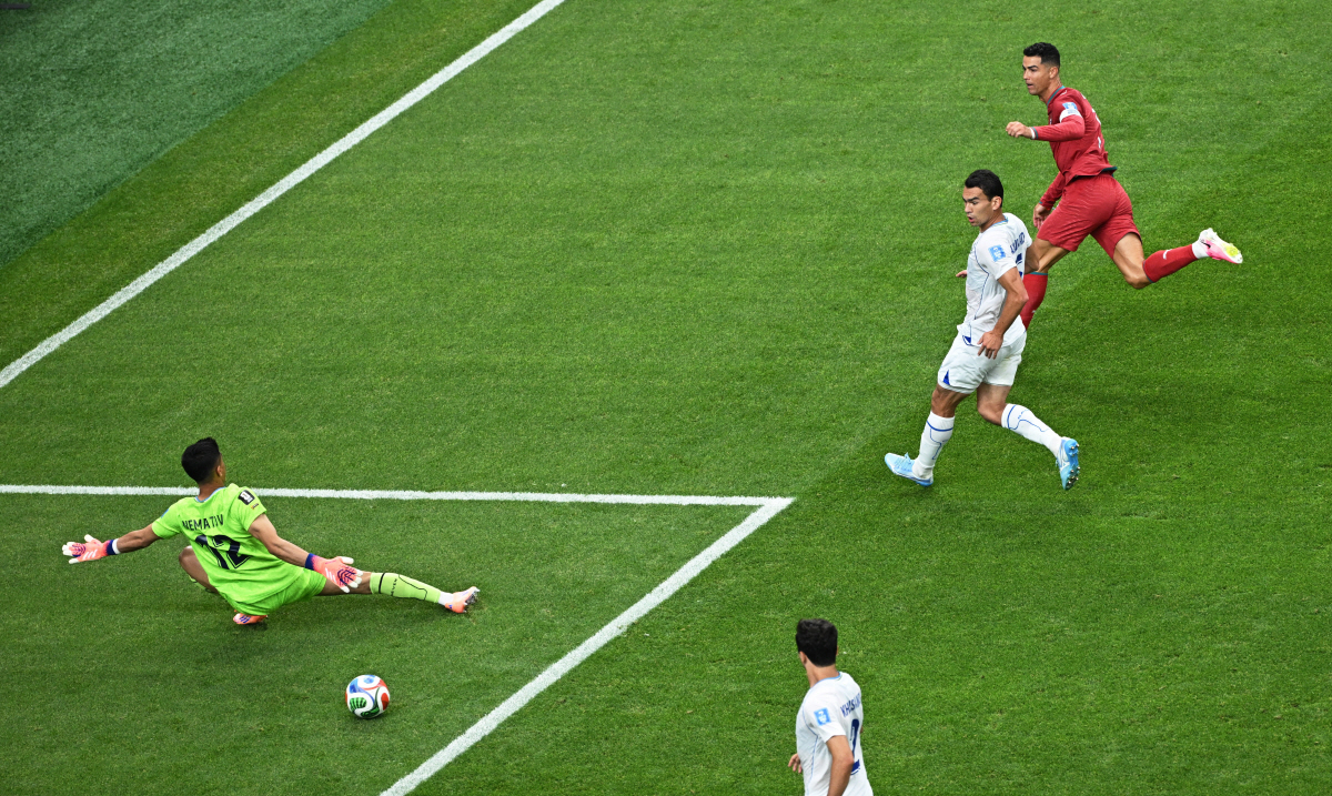 Soccer Football - FIFA World Cup 2026 - Group K - Portugal v Uzbekistan - Houston Stadium, Houston, Texas, U.S. - June 23, 2026 Portugal's Cristiano Ronaldo scores their third goal past Uzbekistan's Abduvohid Nematov REUTERS/Annegret Hilse