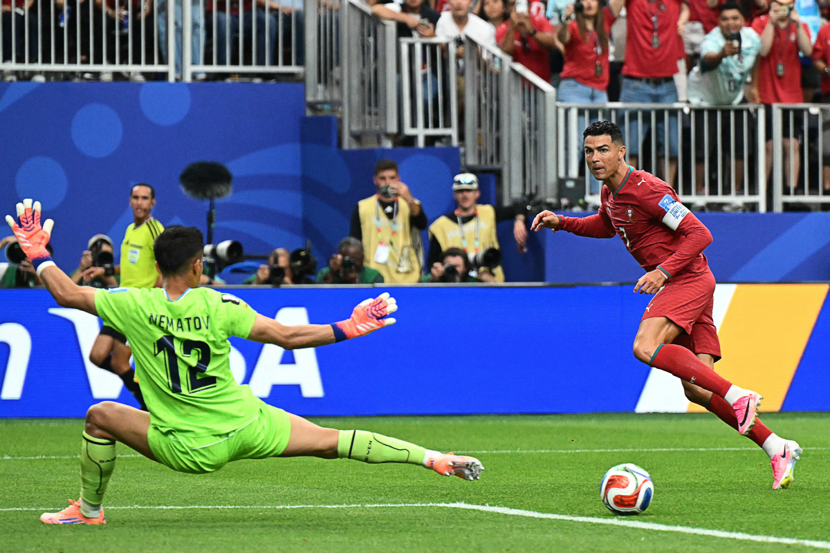 Portugal's forward #07 Cristiano Ronaldo (R) reacts as he scores his team's third goal during t