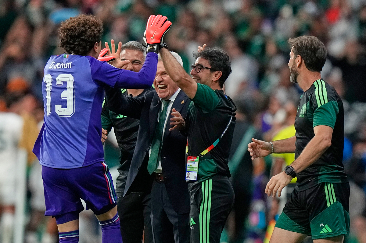 Mexico goalkeeper Guillermo Ochoa (13) celebrates with Mexico head coach Javier Aguirre, centre, after teammate Alvaro Fidalgo (8) scored their third goal during the World Cup Group A soccer match between Czechia and Mexico in Mexico City, Wednesday, June 24, 2026. (AP Photo/Fernando Llano)