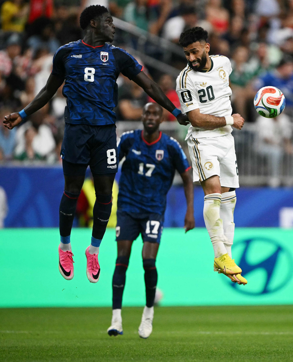 Cape Verde's defender #08 Joao Paulo (L) and Saudi Arabia's midfielder #20 Sultan Mandash jump for the ball during the 2026 World Cup Group H football match between Cape Verde and Saudi Arabia at the Houston Stadium in Houston on June 26, 2026. (Photo by RONALDO SCHEMIDT / AFP)