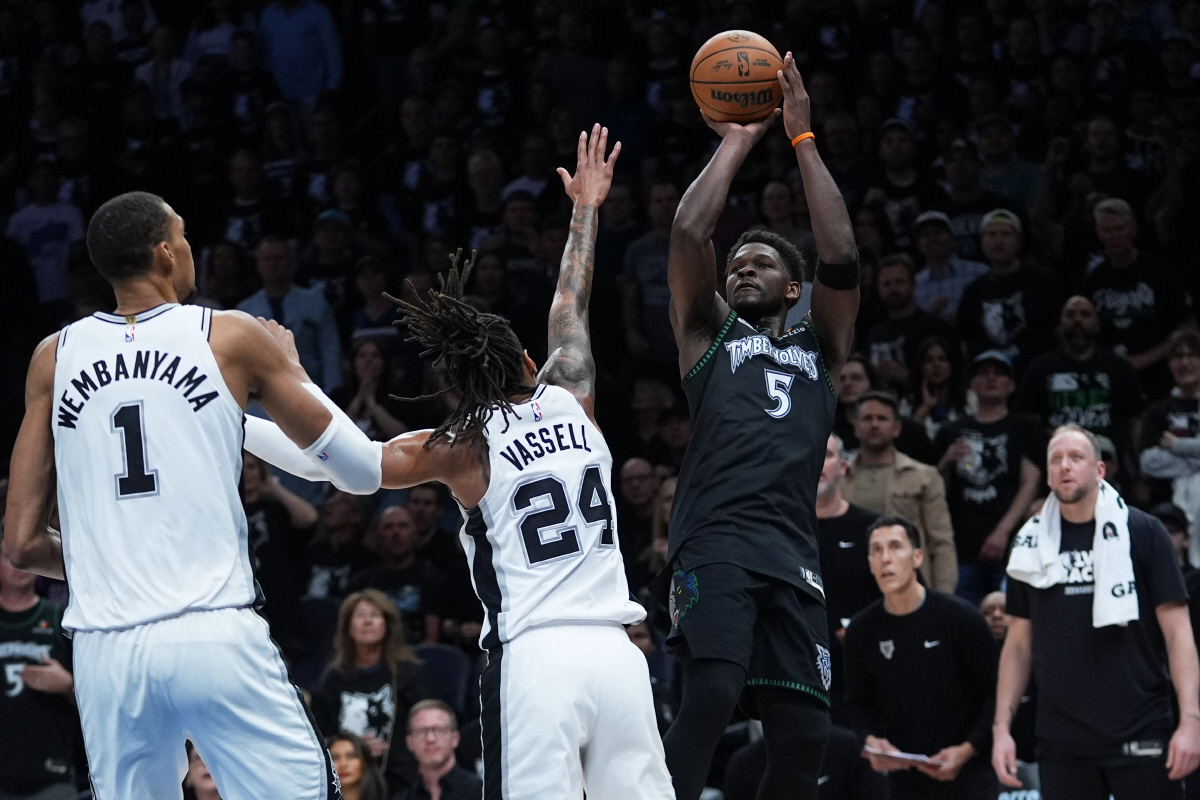 Minnesota Timberwolves guard Anthony Edwards (5) shoots over San Antonio Spurs forward Victor Wembanyama (1) and guard Devin Vassell (24) during the first half of Game 6 of an NBA basketball second-round playoffs series against the San Antonio Spurs in Minneapolis, Friday, May 15, 2026. (AP Photo/Abbie Parr)