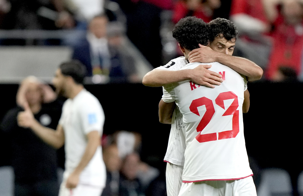 epa13068269 Shojae Khalilzadeh (facing) and Ramin Rezaeian of Iran celebrate at the end of the FIFA World Cup 2026 group stage match Egypt against Iran, in Seattle, USA, 26 June 2026. The match ended 1-1. EPA/STEPHEN BRASHEAR