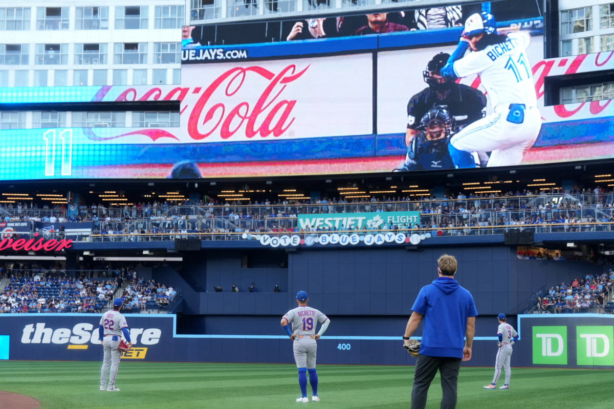 New York Mets third baseman Bo Bichette (19) watches a tribute video from his time on the Toronto Blue Jay before a baseball game between the Blue Jays and the Mets in Toronto, Monday, June 29, 2026. (Nathan Denette/The Canadian Press via AP) MANDATORY CREDIT