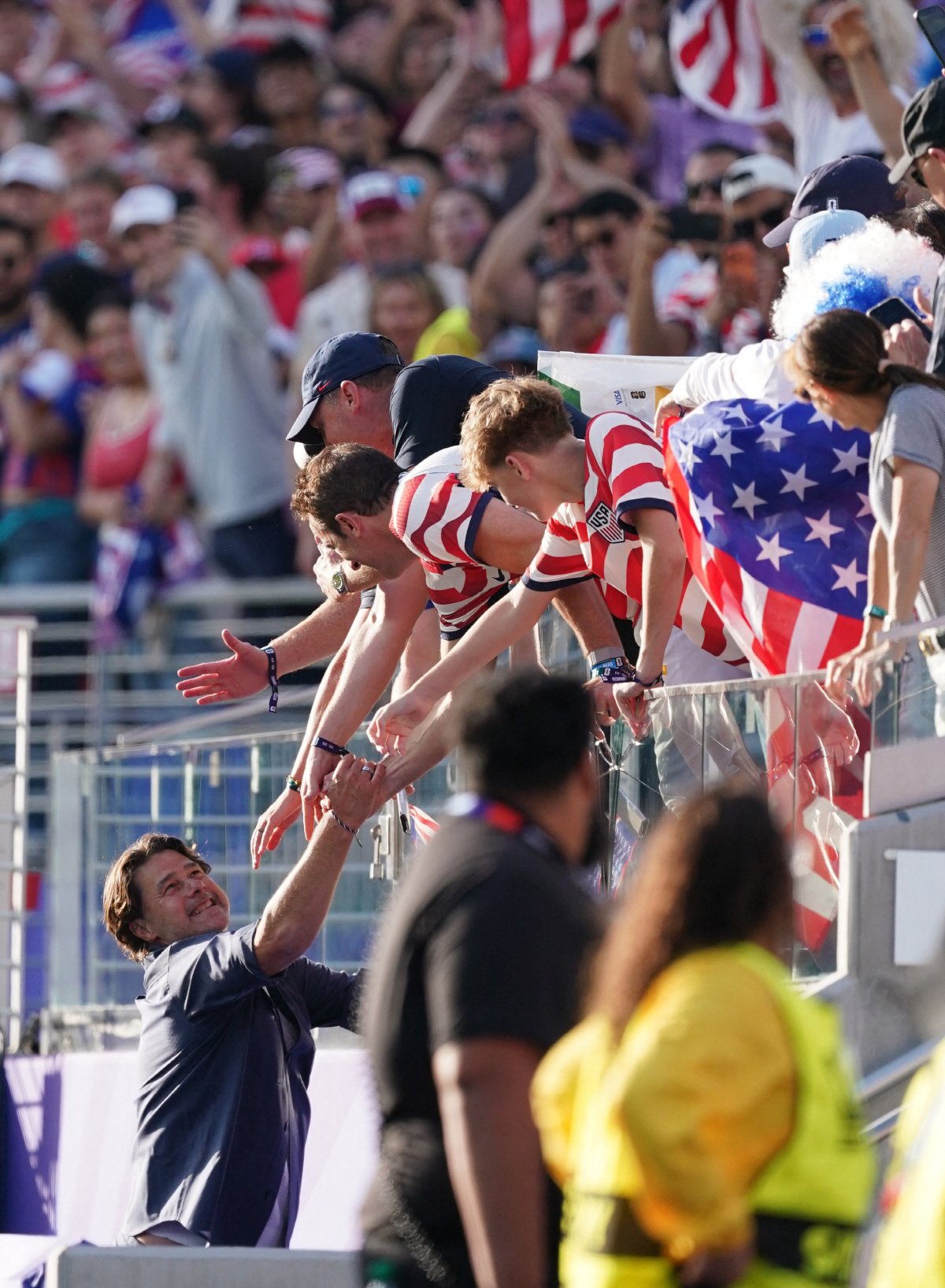 Soccer Football - FIFA World Cup 2026 - Round of 32 - United States v Bosnia and Herzegovina - San Francisco Bay Area Stadium, Santa Clara, California, U.S. - July 1, 2026 U.S. coach Mauricio Pochettino celebrates with fans after the match as United States qualify for the round of 16 stage of the World Cup IMAGN IMAGES via Reuters/David Gonzales