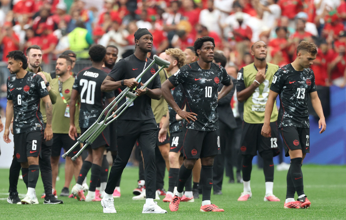 Canada's players react after losing the 2026 World Cup round of 16 football match between Canada and Morocco at the Houston Stadium in Houston on July 4, 2026. (Photo by Thomas COEX / AFP)