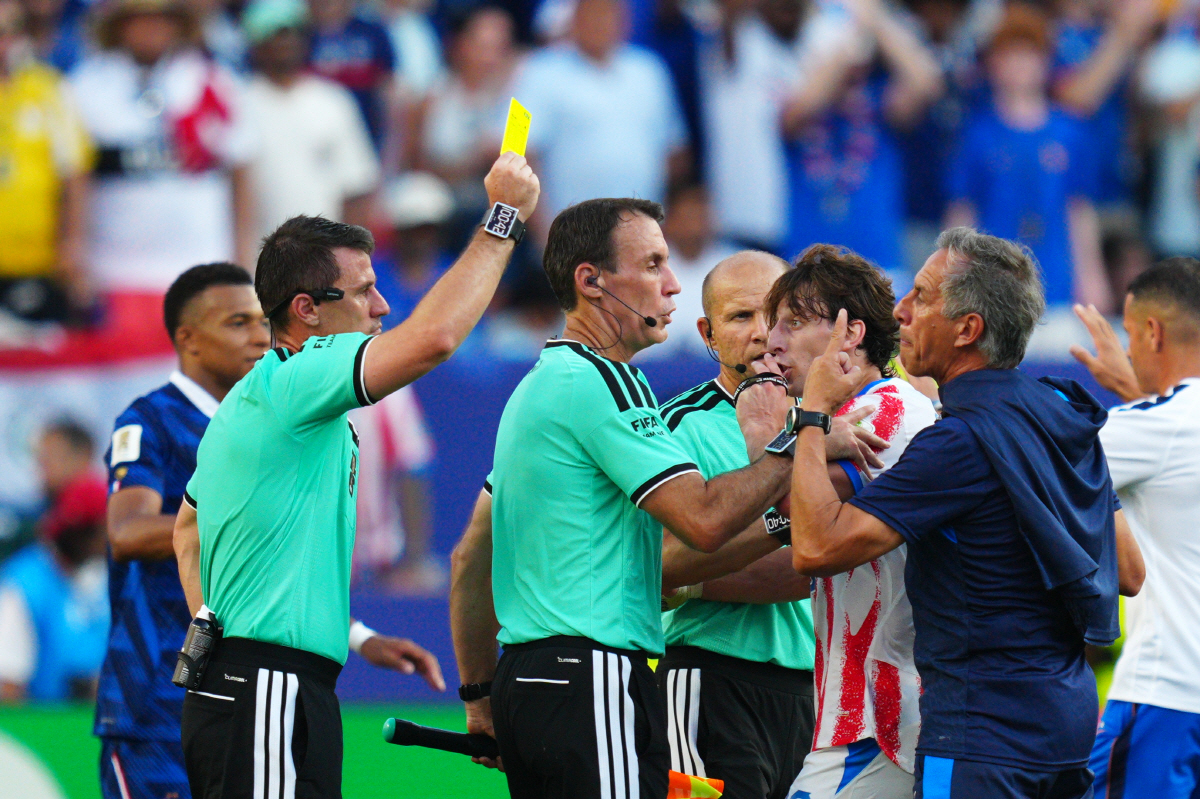 Referee Ilgiz Tantashev, of Uzbekistan, a yellow card to a member of the Paraguayan team after the end of the World Cup round of 16 soccer match between Paraguay and France in Philadelphia, Saturday, July 4, 2026. (AP Photo/Derik Hamilton)