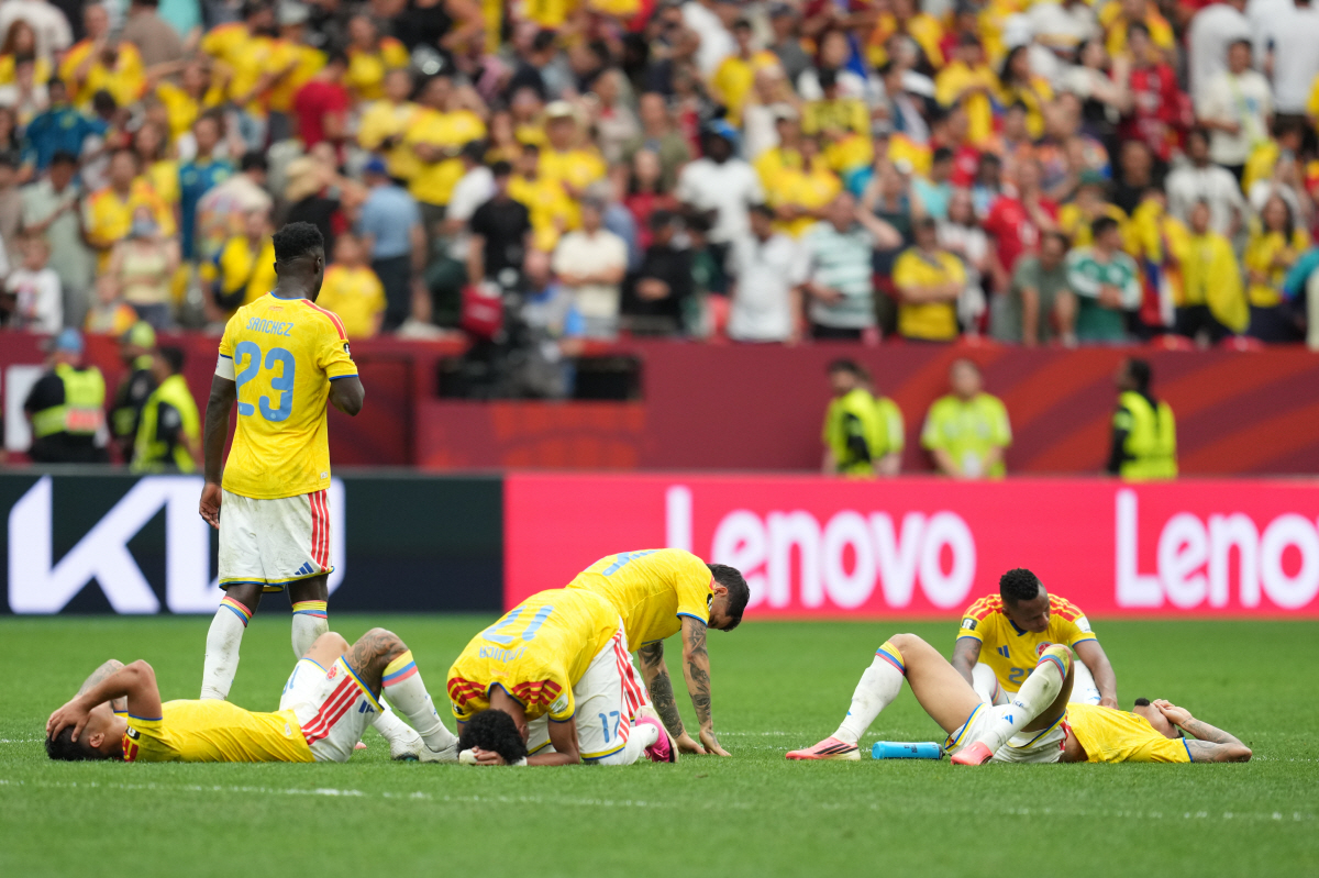 Colombian players lie dejected after losing penalty shootout