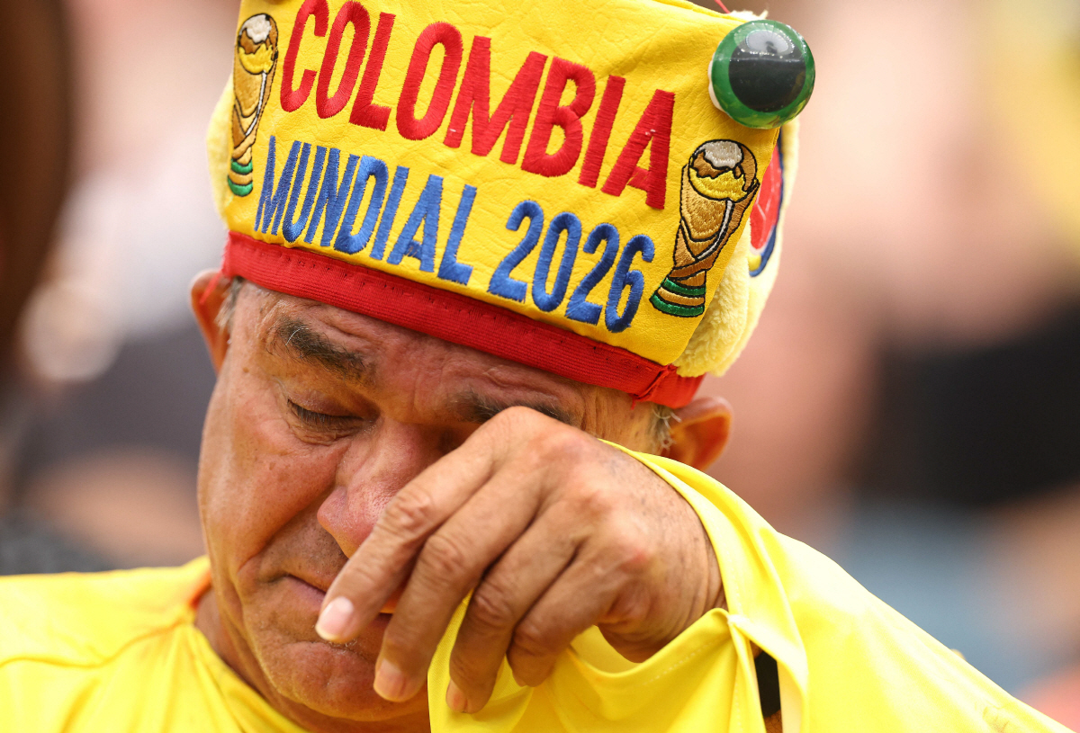 A Colombia fan reacts after the penalty shootout loss