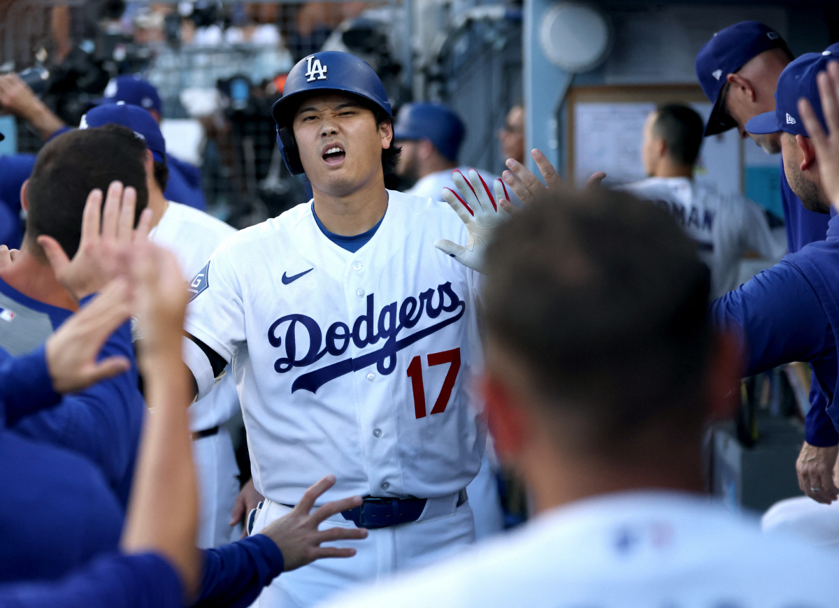 LOS ANGELES, CALIFORNIA - JULY 07: Shohei Ohtani #17 of the Los Angeles Dodgers reacts in the dugout to a solo home run, his 300th for his career, to take a 1-0 lead over the Colorado Rockies, during the first inning at Dodger Stadium on July 07, 2026 in Los Angeles, California. Harry How/Getty Images/AFP (Photo by Harry How / GETTY IMAGES NORTH AMERICA / Getty Images via AFP)