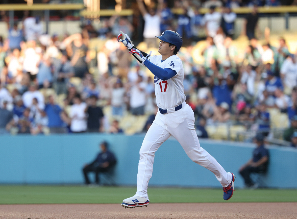 LOS ANGELES, CALIFORNIA - JULY 07: Shohei Ohtani #17 of the Los Angeles Dodgers reacts to a solo home run, his 300th for his career, to take a 1-0 lead over the Colorado Rockies, during the first inning at Dodger Stadium on July 07, 2026 in Los Angeles, California. Harry How/Getty Images/AFP (Photo by Harry How / GETTY IMAGES NORTH AMERICA / Getty Images via AFP)