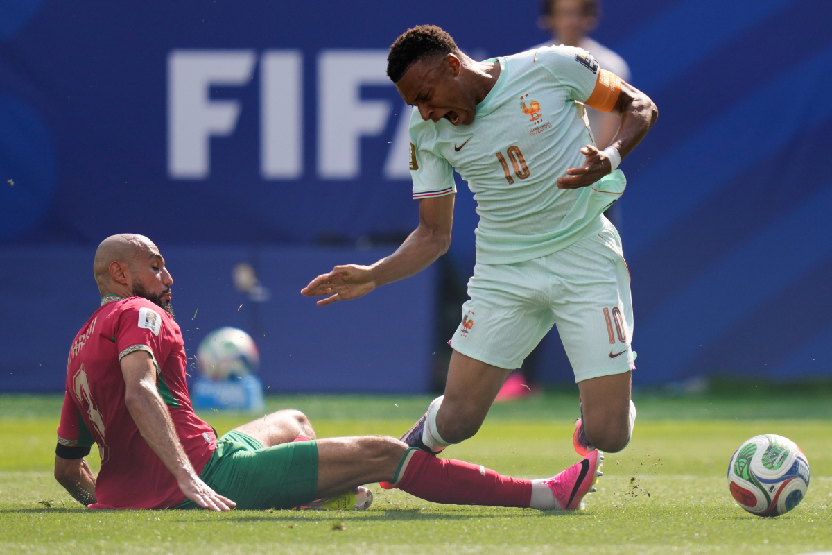 Morocco's Noussair Mazraoui (3) fouls France's Kylian Mbappe (10) during the World Cup quarterfinal soccer match between France and Morocco in Foxborough, Mass., near Boston, Thursday, July 9, 2026. (AP Photo/Charles Krupa)