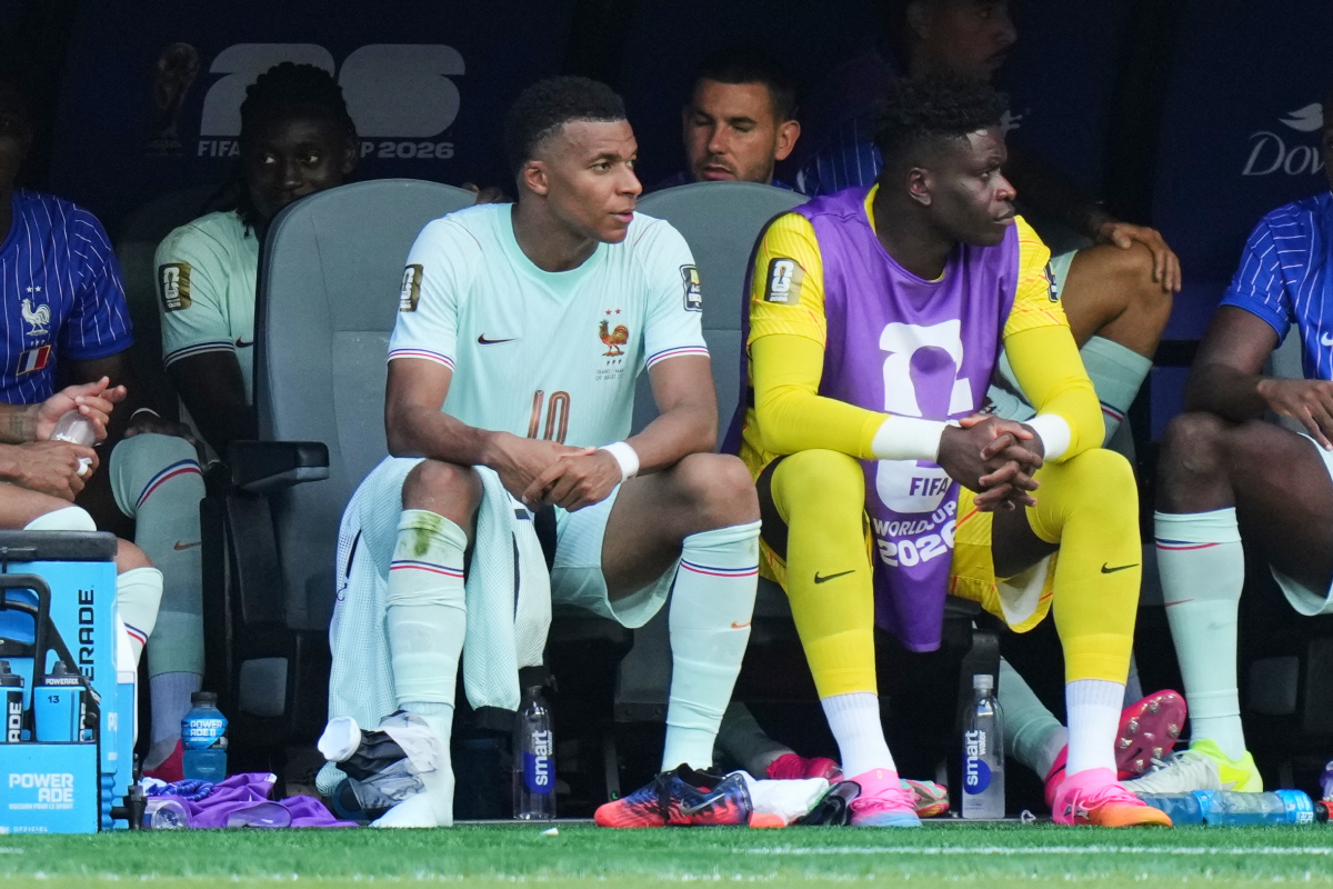 France's Kylian Mbappe, left, sits on the bench with his right lower ankle region wrapped during the World Cup quarterfinal soccer match between France and Morocco in Foxborough, Mass., near Boston, Thursday, July 9, 2026. (AP Photo/Stephanie Scarbrough)