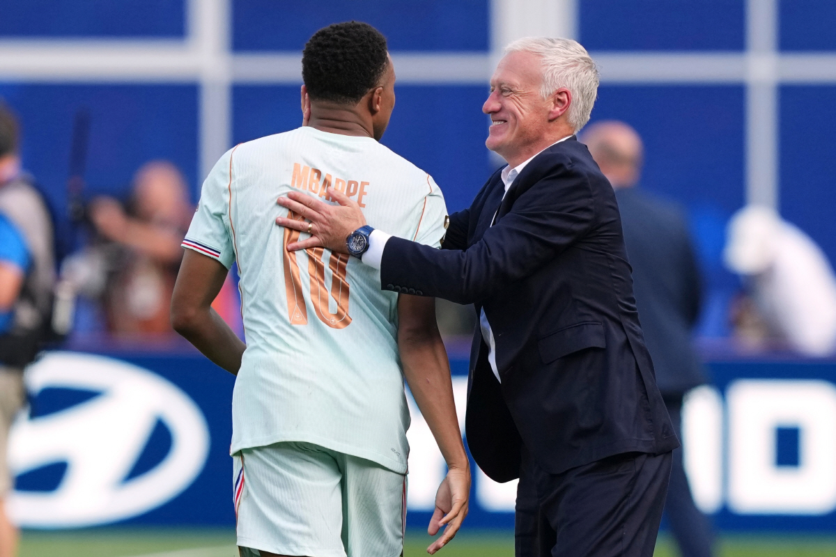 France's Kylian Mbappe (10) is hugged by France head coach Didier Deschamps France defeated Morocco in the World Cup quarterfinal soccer match between France and Morocco in Foxborough, Mass., near Boston, Thursday, July 9, 2026. (AP Photo/Martin Meissner)