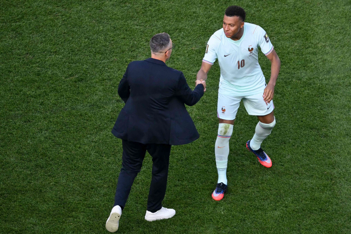 France's forward #10 Kylian Mbappe shakes hands with Morocco's head coach Mohamed Ouahbi after France won the 2026 World Cup football tournament quarter-final match against Morocco at Boston Stadium in Foxborough on July 9, 2026. (Photo by ANGELA WEISS / AFP)