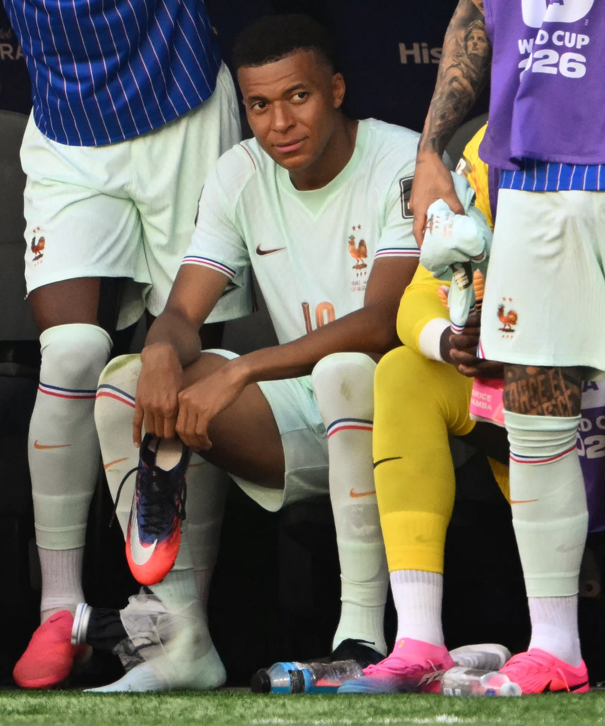 France's forward #10 Kylian Mbappe sits with an ice pack on his ankle during the 2026 World Cup football tournament quarter-final match between France and Morocco at Boston Stadium in Foxborough on July 9, 2026. (Photo by MAURO PIMENTEL / AFP)