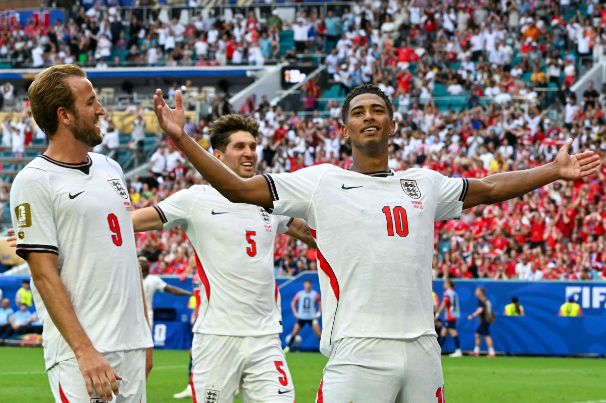 England's midfielder #10 Jude Bellingham celebrates scoring his team's second goal with England's forward #09 Harry Kane and England's defender #05 John Stones during the 2026 World Cup football tournament quarter-final match between Norway and England at Miami Stadium in Miami on July 11, 2026. (Photo by ROBERTO SCHMIDT / AFP)