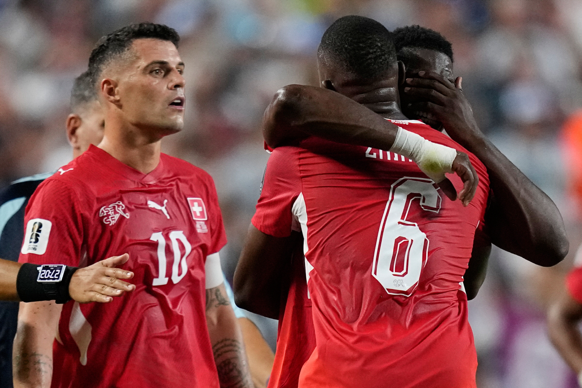 Switzerland's Breel Embolo, right, is consoled by teammate Denis Zakaria (6) after he was given a red card during the World Cup quarterfinal soccer match between Argentina and Switzerland in Kansas City, Mo., Saturday, July 11, 2026. (AP Photo/Ashley Landis)
