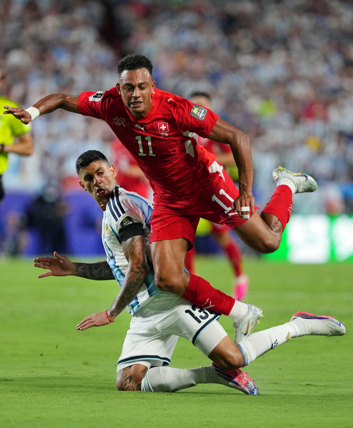 Soccer Football - FIFA World Cup 2026 - Quarter Final - Argentina v Switzerland - Kansas City Stadium, Kansas City, Missouri, U.S. - July 11, 2026 Switzerland's Dan Ndoye in action with Argentina's Cristian Romero IMAGN IMAGES via Reuters/Jay Biggerstaff