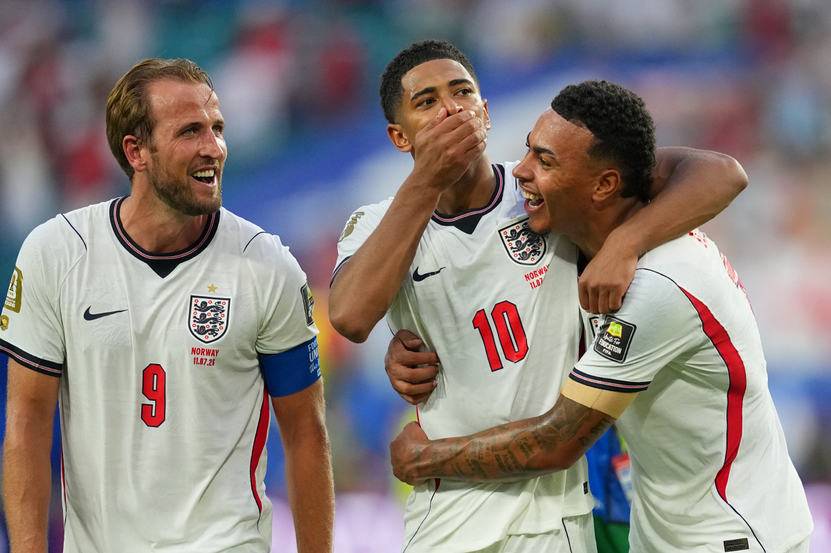 England's Harry Kane, left, Jude Bellingham, center, and Morgan Rogers celebrate defeating Norway in a World Cup quarterfinal soccer match in Miami Gardens, Fla., Saturday, July 11, 2026. (AP Photo/Julio Cortez)