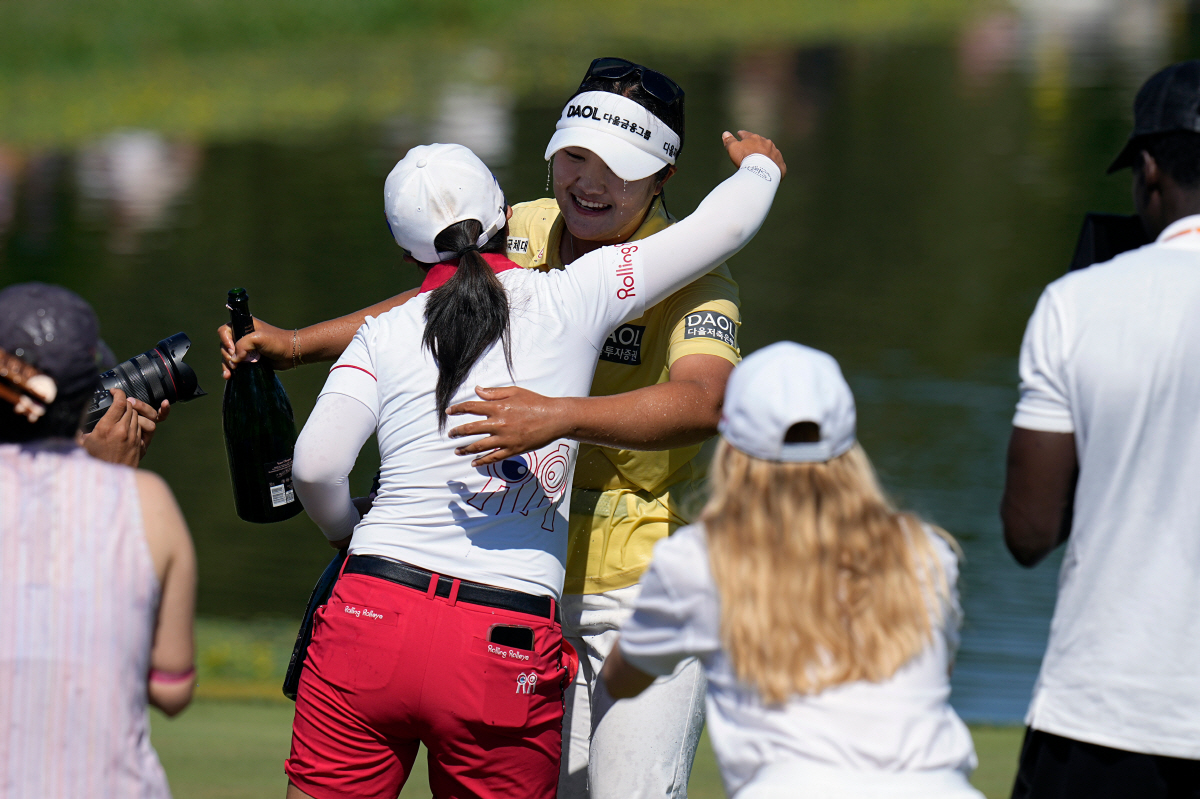Haeran Ryu, of South Korea, celebrates with her teammates after winning the Evian Championship women's golf tournament, in Evian, eastern France, Sunday, July 12, 2026. (AP Photo/Laurent Cipriani)