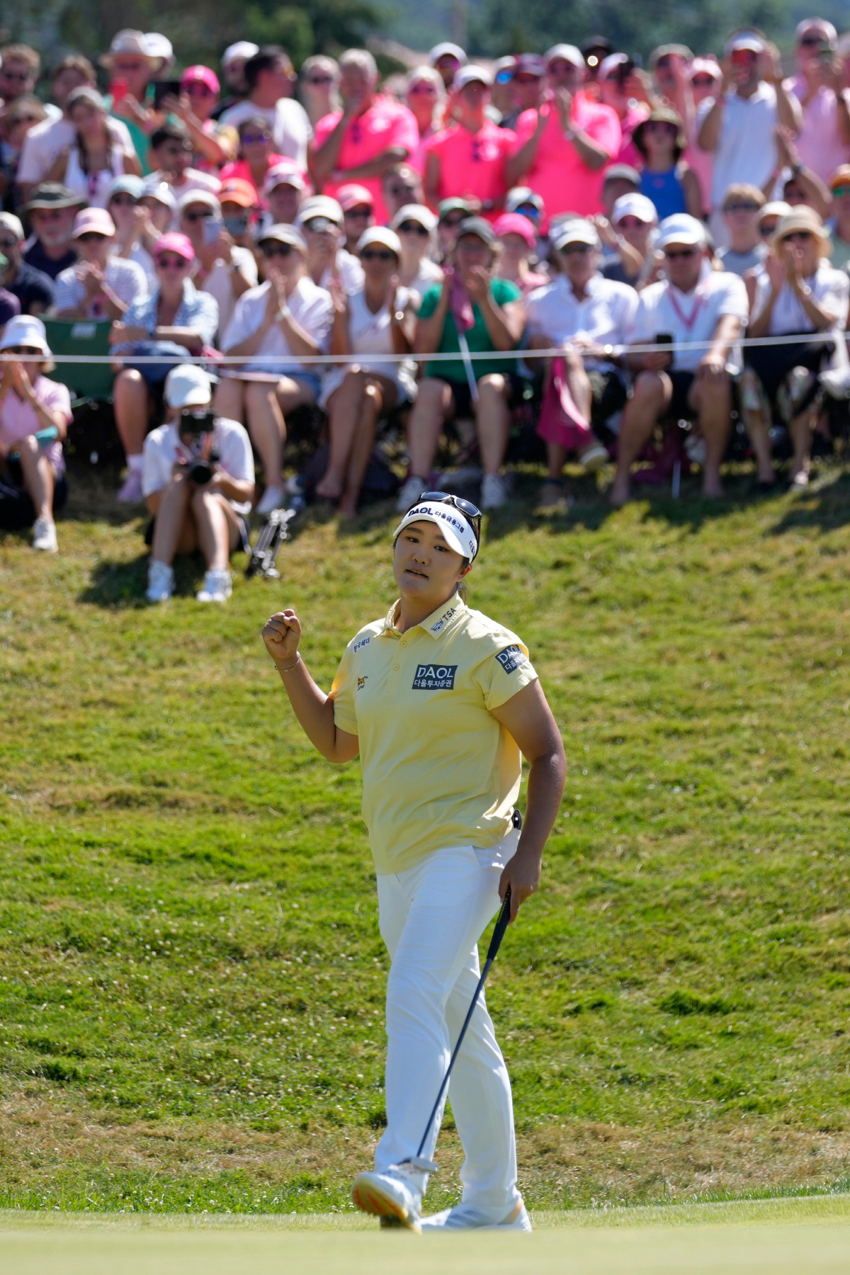 Haeran Ryu, of South Korea, celebrates on the 18th hole during the Evian Championship women's golf tournament, in Evian, eastern France, Sunday, July 12, 2026. (AP Photo/Laurent Cipriani)