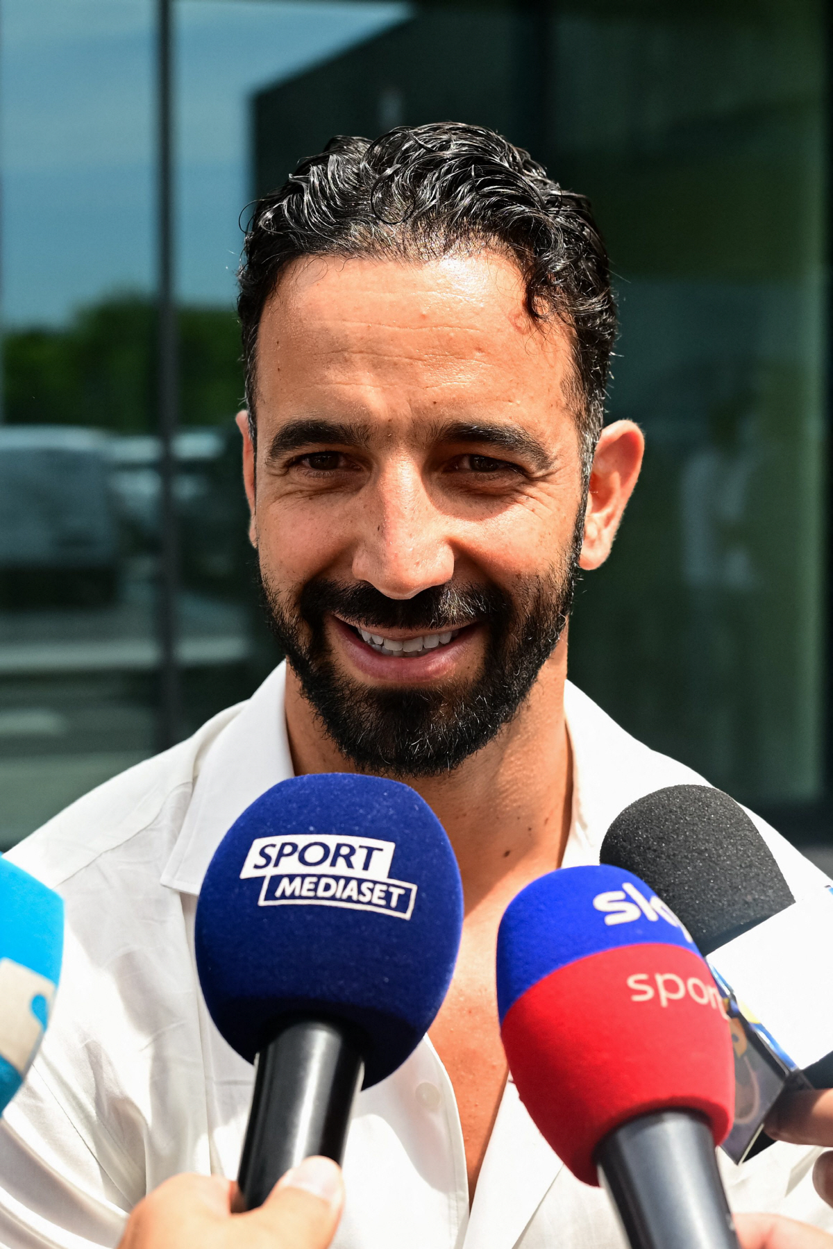 Italian football club AC Milan's newly recruited Portuguese coach Ruben Amorim talks to the press as he leaves Linate Airport after his arrivhal in Milan on July 6, 2026. (Photo by Piero CRUCIATTI / AFP)