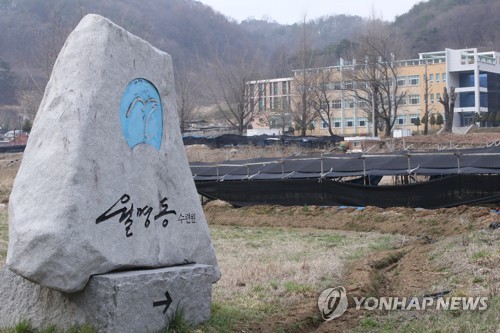 (금산=연합뉴스) 강수환 기자 = 23일 기독교복음선교회(통칭 JMS) 총재 정명석 씨의 여신도 성폭행 혐의 사건과 관련 검·경이 충남 금산 월명동 JMS 수련원과 세계선교본부를 압수수색하고 있다. 사진은 월명동 수련원으로 가는 이정표시석. 2023.3.23. swan@yna.co.kr
