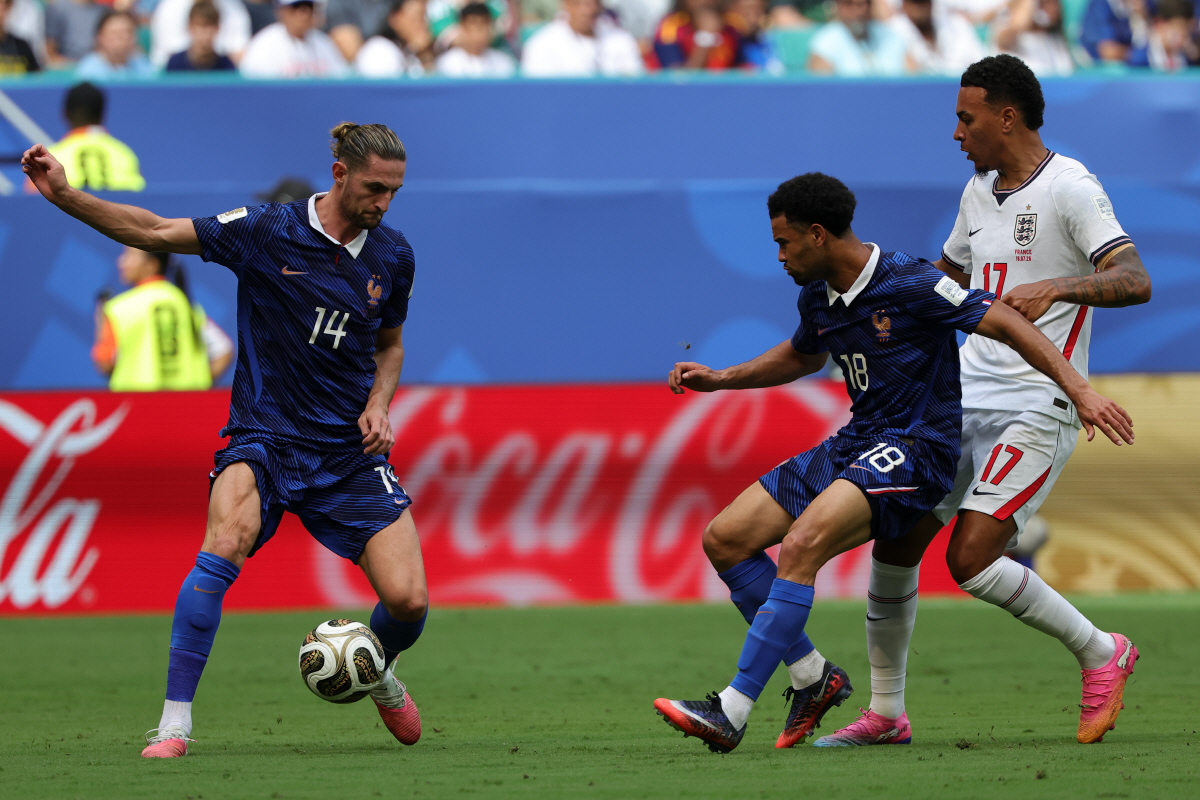 epa13119618 Adrien Rabiot of France (L), Warren Zaire-Emery of France (C), and Morgan Rogers of England (R) in action during the FIFA World Cup 2026 3rd place playoff match France against England, in Miami, Florida, USA, 18 July 2026. EPA/CRISTOBAL HERRERA-ULASHKEVICH